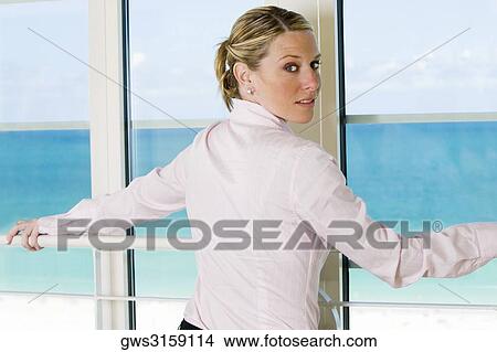 Rear view of a businesswoman standing beside a window View Large Photo Image Picture - Rear view of a businesswoman standing beside a window. Fotosearch