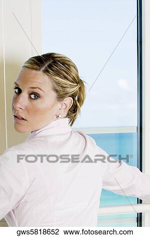 Rear view of a businesswoman standing beside a window View Large Photo Image Stock Image - Rear view of a businesswoman standing beside a window. Fotosearch
