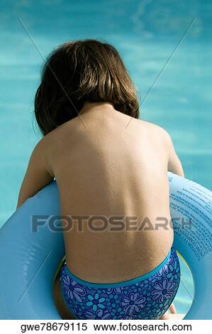 Rear view of a girl in an inflatable ring View Large Photo Image Stock Photography - Rear view of a girl in an inflatable ring. Fotosearch
