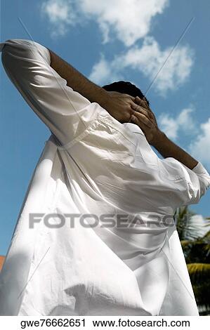Rear view of a young man standing with hands behind his head View Large Photo Image Stock Image - Rear view of a young man standing with hands behind his head. Fotosearch
