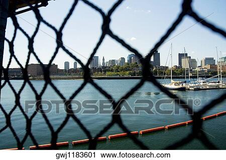 Sailboats in a river seen through a chain-link fence, Boston, Massachusetts, USA View Large Photo Image Stock Image - Sailboats in a river seen through a chain-link fence, Boston, Massachusetts, USA. Fotosearch