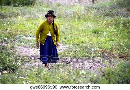 Stock Image - Senior woman standing in a field. Fotosearch