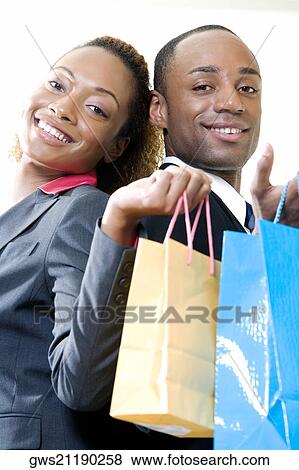 Stock Photo - Side profile of a businessman and a businesswoman standing back to back. Fotosearch