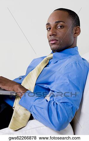 Side profile of a businessman using a laptop View Large Photo Image Stock Photo - Side profile of a businessman using a laptop. Fotosearch