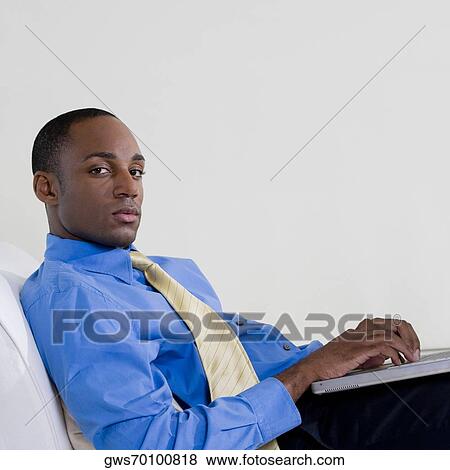 Side profile of a businessman using a laptop View Large Photo Image Stock Photo - Side profile of a businessman using a laptop. Fotosearch