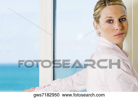 Side profile of a businesswoman standing beside a window View Large Photo Image Stock Image - Side profile of a businesswoman standing beside a window. Fotosearch