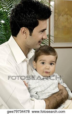 Side profile of a father holding his son View Large Photo Image Stock Photo - Side profile of a father holding his son. Fotosearch