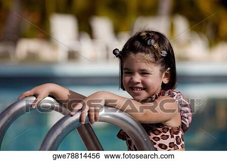 Side profile of a girl smiling by the pool View Large Photo Image Stock Photograph - Side profile of a girl smiling by the pool. Fotosearch