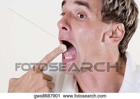 Side profile of a mid adult man eating a fruit tart View Large Photo Image Stock Image - Side profile of a mid adult man eating a fruit tart. Fotosearch