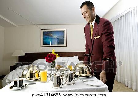 Stock Photography - Side profile of a waiter serving food. Fotosearch