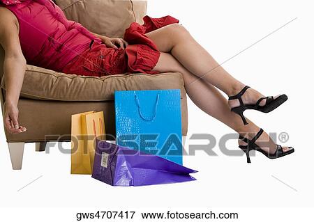 Stock Photo - Side profile of a woman lying on a couch. Fotosearch