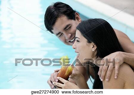 Side profile of a young couple holding a glass of drink View Large Photo Image Stock Image - Side profile of a young couple holding a glass of drink. Fotosearch