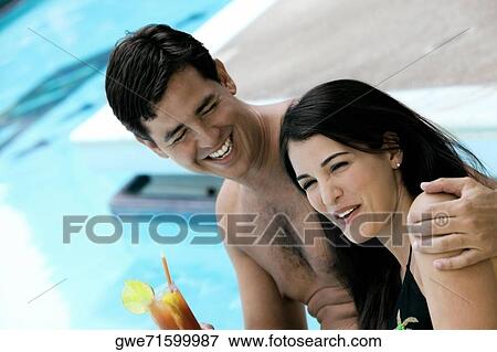 Side profile of a young couple smiling View Large Photo Image Stock Photo - Side profile of a young couple smiling. Fotosearch