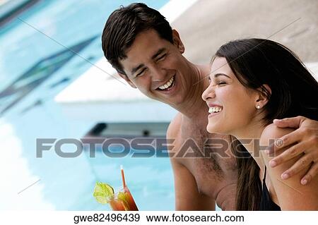 Side profile of a young couple smiling View Large Photo Image Stock Photo - Side profile of a young couple smiling. Fotosearch