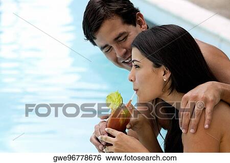Side profile of a young man giving a sip to a young woman View Large Photo Image Stock Photograph - Side profile of a young man giving a sip to a young woman. Fotosearch