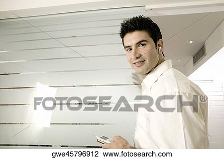 Side profile of a young man listening to an MP3 Player View Large Photo Image Stock Image - Side profile of a young man listening to an MP3 Player. Fotosearch