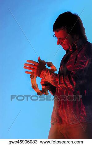 Side profile of a young man playing the tambourine View Large Photo Image Stock Image - Side profile of a young man playing the tambourine. Fotosearch