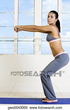Stock Photography - Side profile of a young woman exercising. Fotosearch