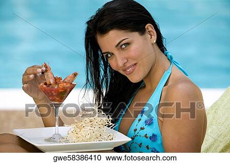 Side profile of a young woman having a meal View Large Photo Image Stock Image - Side profile of a young woman having a meal. Fotosearch
