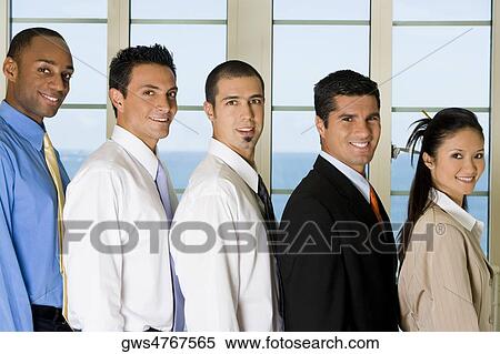 Stock Photography - Side profile of four businessmen and a businesswoman standing in a row. Fotosearch