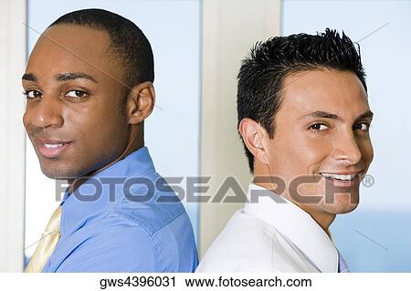 Side profile of two businessmen back to back View Large Photo Image Stock Image - Side profile of two businessmen back to back. Fotosearch