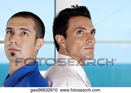 Side profile of two businessmen standing back to back View Large Photo Image Stock Image - Side profile of two businessmen standing back to back. Fotosearch