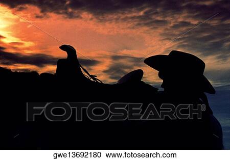 Silhouette of a person standing beside a horse View Large Photo Image Stock Image - Silhouette of a person standing beside a horse. Fotosearch