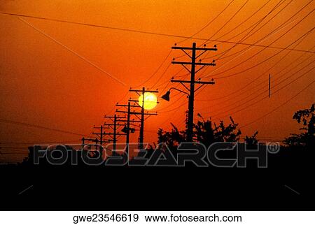 Silhouette of electricity pylons and power lines at sunset View Large Photo Image Stock Photo - Silhouette of electricity pylons and power lines at sunset. Fotosearch