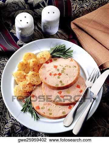 Stock Image - Slice of salami with potato in a plate. Fotosearch