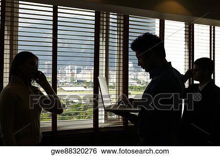 Three business executive in an office View Large Photo Image Stock Photograph - Three business executive in an office. Fotosearch