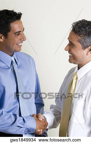 Two businessmen shaking hands View Large Photo Image Picture - Two businessmen shaking hands. Fotosearch