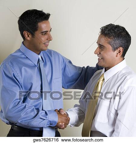 Stock Photograph - Two businessmen shaking hands. Fotosearch