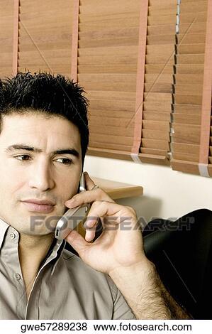 Two young businessmen working in an office View Large Photo Image Stock Photo - Two young businessmen working in an office. Fotosearch