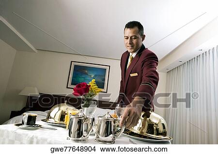 Picture - Waiter serving food. Fotosearch