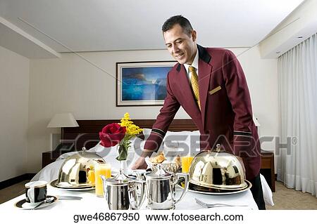 Waiter serving food View Large Photo Image Stock Image - Waiter serving food. Fotosearch