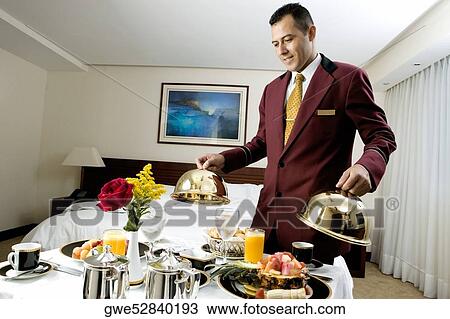 Waiter serving food View Large Photo Image Stock Image - Waiter serving food. Fotosearch