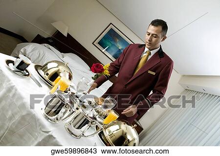 Waiter serving food View Large Photo Image Stock Image - Waiter serving food. Fotosearch