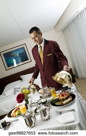 Waiter serving food View Large Photo Image Stock Image - Waiter serving food. Fotosearch