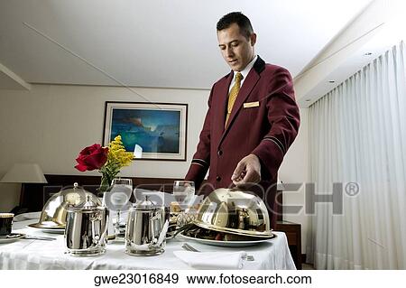 Waiter serving food View Large Photo Image Stock Photo - Waiter serving food. Fotosearch