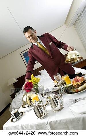 Waiter serving food View Large Photo Image Stock Photo - Waiter serving food. Fotosearch