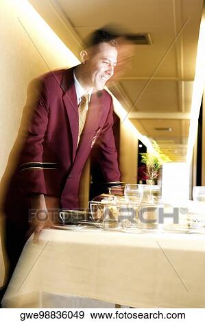 Waiter serving food View Large Photo Image Stock Photo - Waiter serving food. Fotosearch