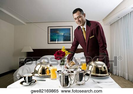Waiter serving food View Large Photo Image Stock Photography - Waiter serving food. Fotosearch