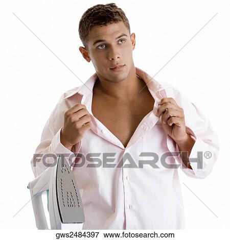 Young man holding his shirt collar View Large Photo Image Stock Photo - Young man holding his shirt collar. Fotosearch