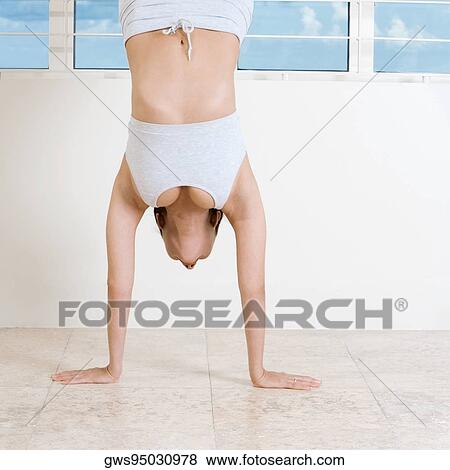 Young woman doing the handstand View Large Photo Image Stock Photo - Young woman doing the handstand. Fotosearch