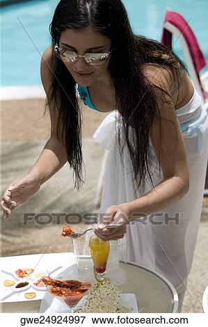 Young woman heaving a meal View Large Photo Image Stock Photo - Young woman heaving a meal. Fotosearch