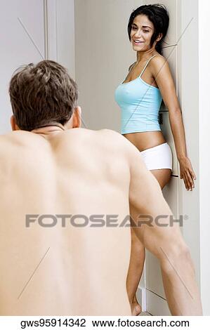 Young woman looking at a young man View Large Photo Image Stock Image - Young woman looking at a young man. Fotosearch