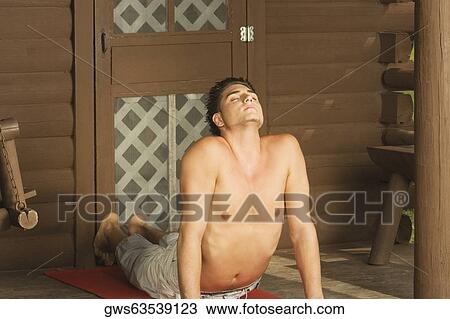 Bare chested young man performing the cobra pose View Large Photo Image Stock Image - Bare chested young man performing the cobra pose. Fotosearch