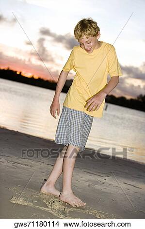 Boy playing on the beach View Large Photo Image Picture - Boy playing on the beach. Fotosearch