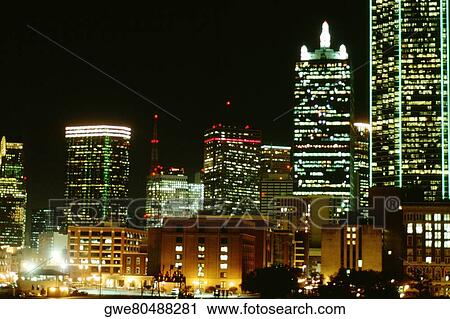 Stock Image - Buildings lit up at night, Dallas, Texas, USA. Fotosearch