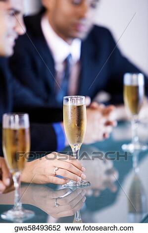 Businessman holding a champagne flute View Large Photo Image Stock Image - Businessman holding a champagne flute. Fotosearch